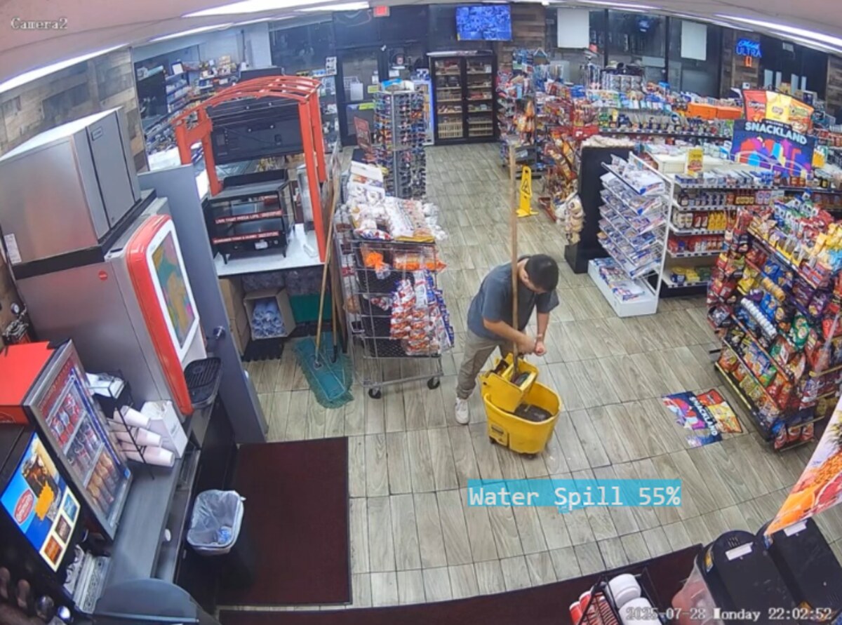 Real CCTV frame: FloorEye AI detecting a water spill on a store floor